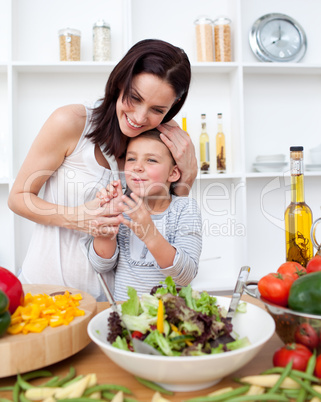 Litlle girl and her mother preparing a salad
