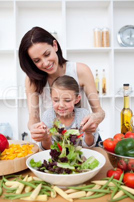 Little girl cooking with her mother