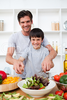 Portrait of a happy father cooking with his son