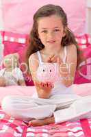 Little girl saving money in a piggybank