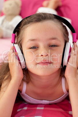 Close-up of a little girl listening musc