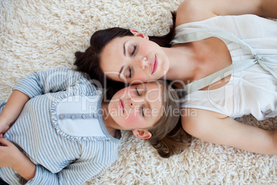 Mother and her daughter slepping on the floor
