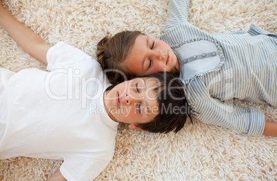 Siblings sleeping on the floor
