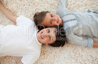 Brother and sister lying on the floor