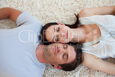 Couple sleeping on the floor