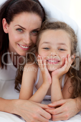 Portrait of a mother and her daughter smiling at the camera