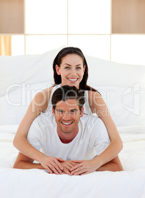 Young couple having fun on bed together