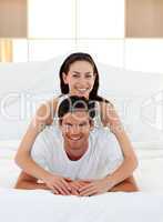 Young couple having fun on bed together
