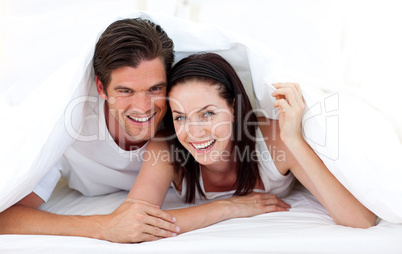 Happy Couple lying on bed