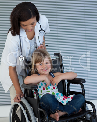Female doctor pushing a wheelchair
