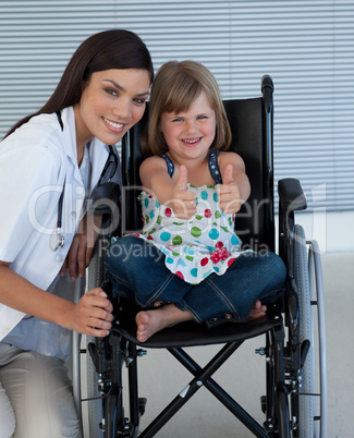 Portrait of a little girl on a wheelchair with her doctor