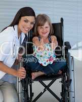 Portrait of a little girl on a wheelchair with her doctor