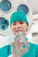 Young doctor applying oxygen mask to a patient