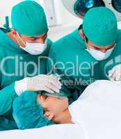 Close-up of surgeons near patient lying on operating table
