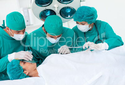 Surgeons near patient lying on an operating table