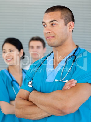 Ethnic doctor with his colleagues in the background