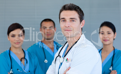 Young male Doctor with his team in the background