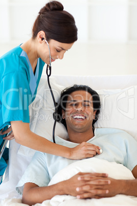 A doctor checking the pulse of a smiling patient
