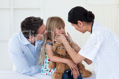 Female doctor examining little girl