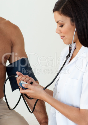 Close-up of a female doctor checking the blood pressure of a pat