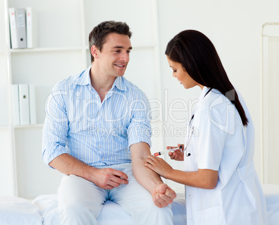 A doctor giving a male patient an injection