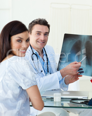 Smiling doctors examining an x-ray
