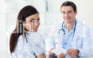 Male doctor giving a prescription to his patient