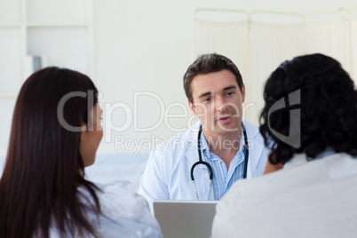 Male doctor explaining diagnosis to a couple