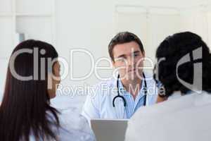 Male doctor explaining diagnosis to a couple