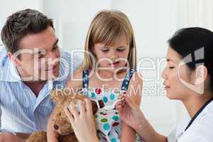 Serious female doctor giving medecne to a little girl