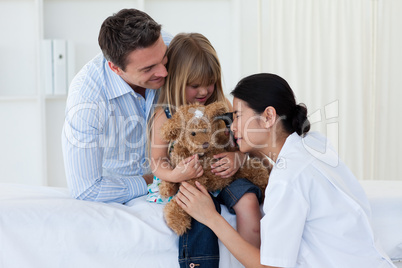 Female doctor playing with a child patient