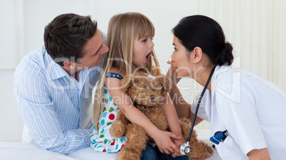 Doctor examining child's throat