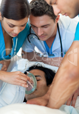 Doctor putting oxygen mask on a patient