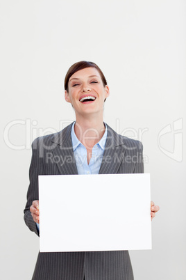 Laughing businesswoman holding white card