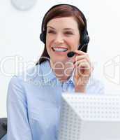 Confident businesswoman with headset on in a call center
