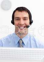 Confident businessman with headset on in a call center