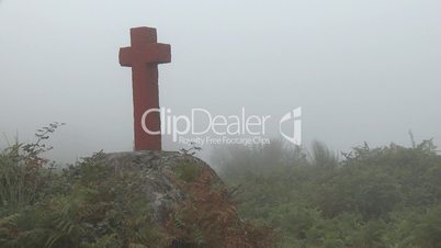 Cross in fog on mountain