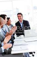 Team of successful business team applauding in a conference