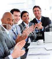 Team of successful multi-ethnic business people applauding