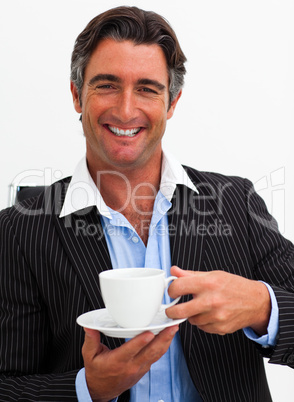 Attractive businessman drinking coffee