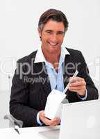 Portrait of a smiling businessman eating chines food