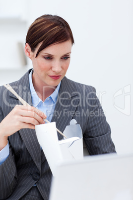 Young businesswoman eating with chopstick
