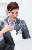 Businesswoman eating chinese food with chopstick