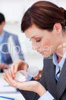 Portrait of a young businesswoman taking pills