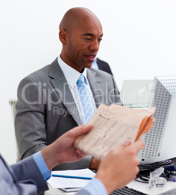 Portrait of an ethnic businessman working at a computer