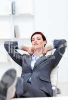 Young Businesswoman sleeping with feet on desk