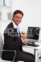 Smiling businessman holding a red apple