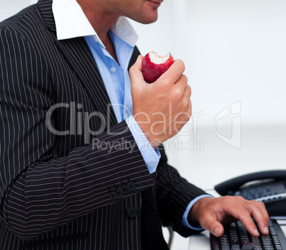 Close-up of a businessman eating a fruit