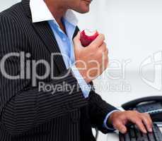 Close-up of a businessman eating a fruit