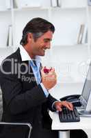 Happy businessman eating a red apple